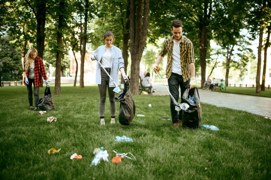 young-people-collects-trash-in-park-volunteering-FB7MKD8