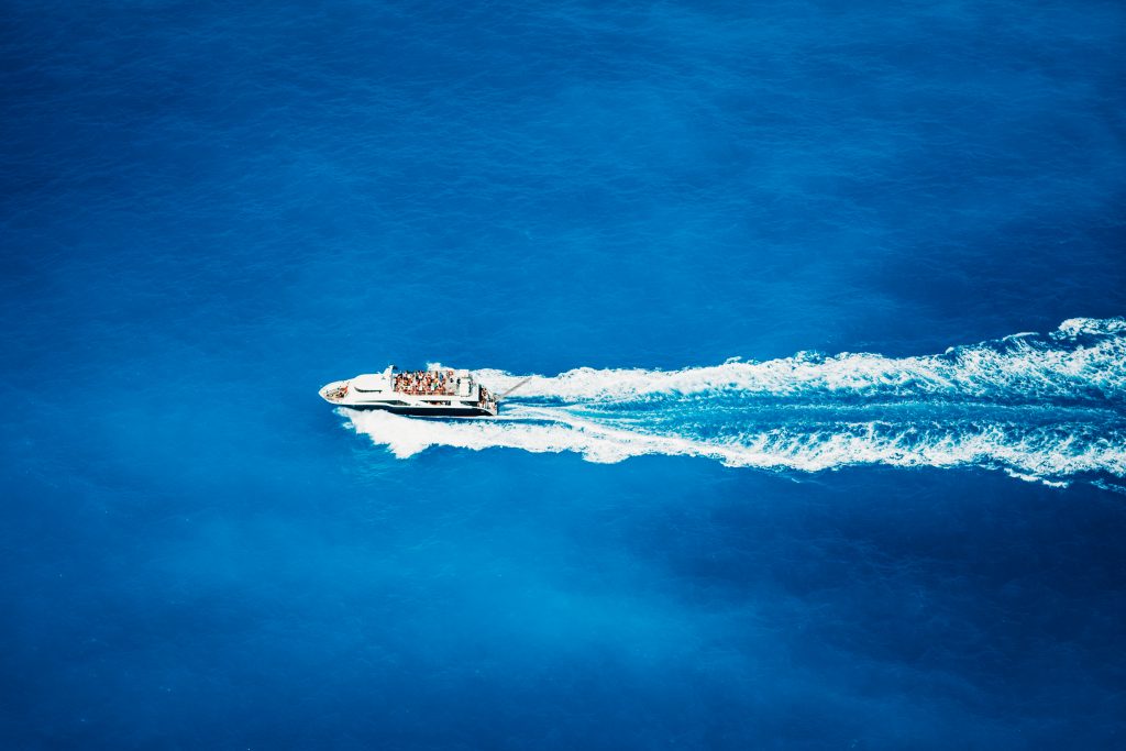 Top view of tourist boat sailing in the sea on full speed