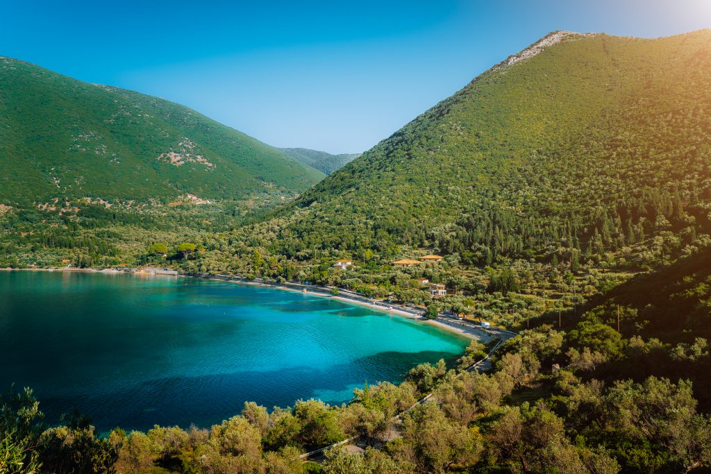 Antisamos beach on Kefalonia island, Greece. Crystal clear water, huge hills overgrown with cypresses, pine and olive trees. Stunning view of mediterranean coasline