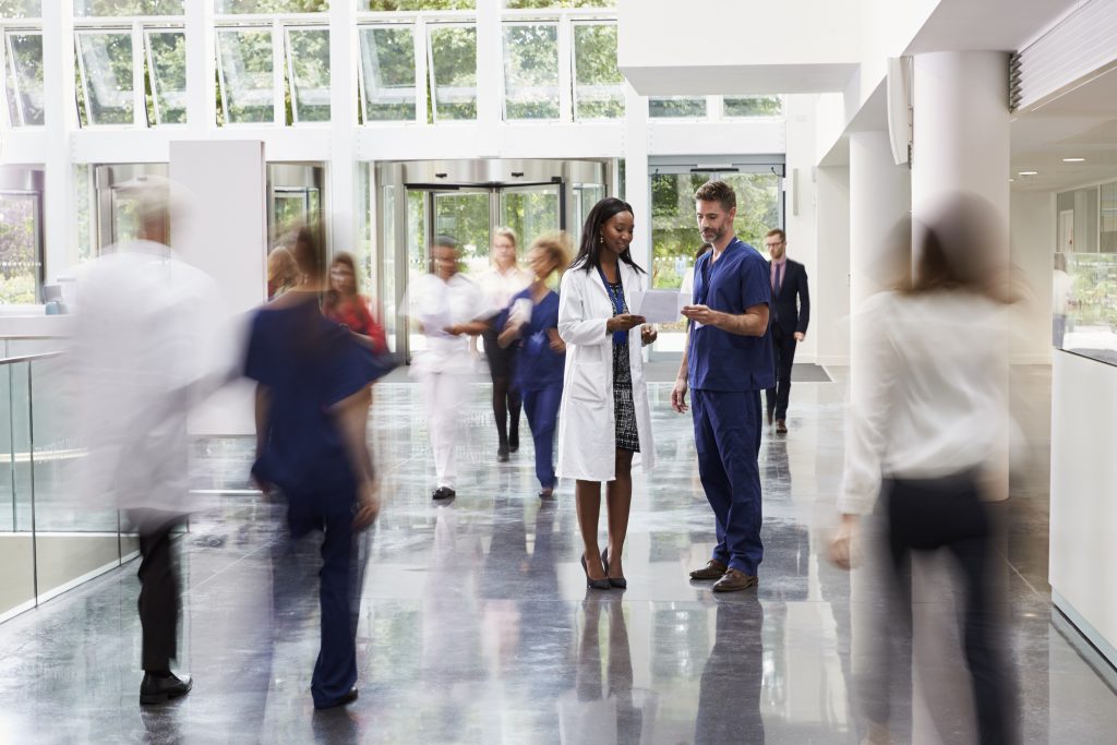 staff-in-busy-lobby-area-of-modern-hospital-PXDLXWT