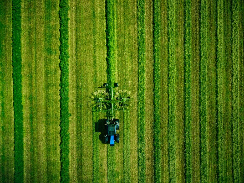 aerial-view-of-tractor-mowing-green-field-in-finla-2022-02-08-22-39-29-utc
