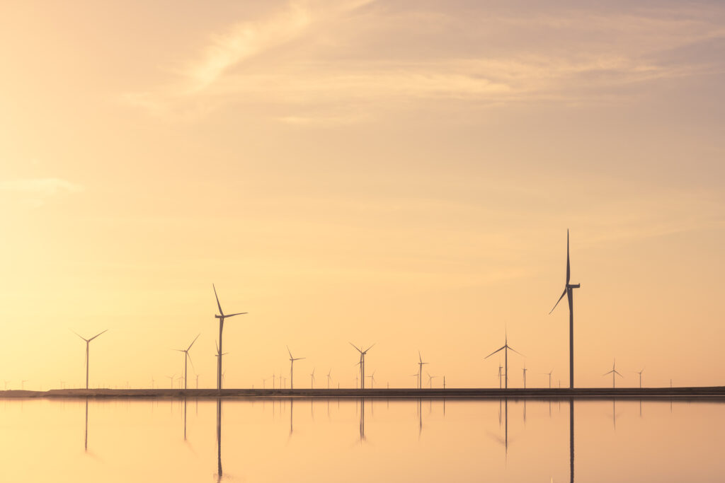 Tranquil minimalist landscape with rows offshore wind turbines