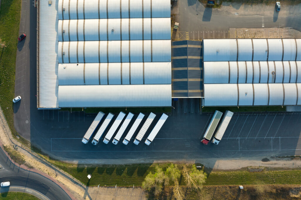 Aerial view of goods warehouses and logistics center in industrial city zone from above