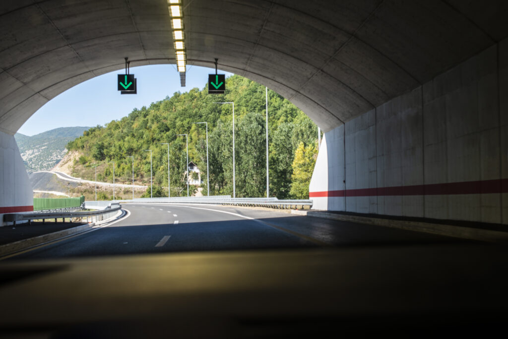 Highway tunnel. Signs in tunnel. Mountain road. Travel and traff