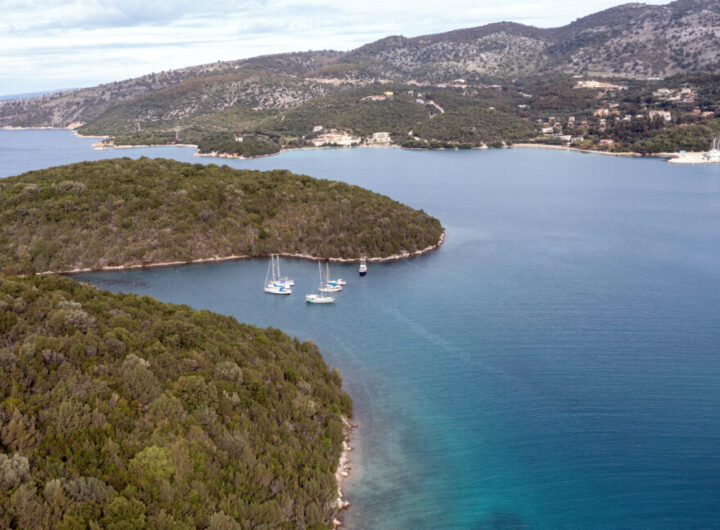 Sailboats anchored in a small bay in Epirus Ionian coast, aerial view. Sailing in Greece, near Sivota