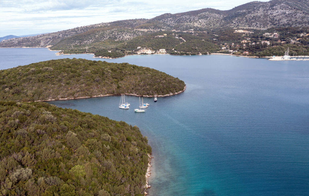 Sailboats anchored in a small bay in Epirus Ionian coast, aerial view. Sailing in Greece, near Sivota